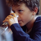 Child drinking water from glass 