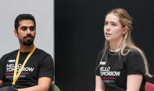 A male and female researcher sat during a panel discussion