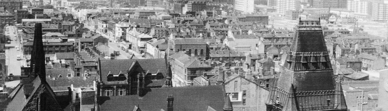Old black and white shot of rooftops in the Manchester skyline