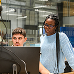 Students looking at some work on a computer