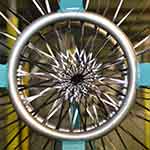 Close-up of a braiding machine showing a maypole pattern