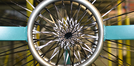 Close-up of a braiding machine showing a maypole pattern