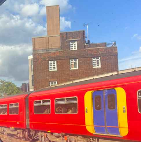Train passing by a building