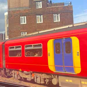 Train passing by a building