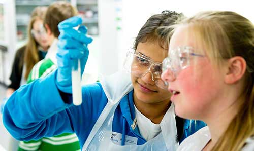 Two young people looking at a test tube