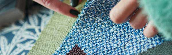 Close up of people flicking through material swatches