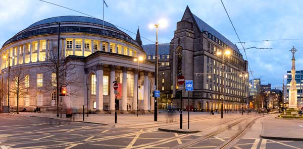 Street view of large dome building beside tram lines