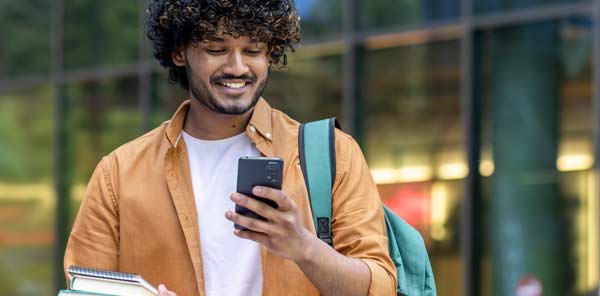 Man looking at his mobile phone and smiling