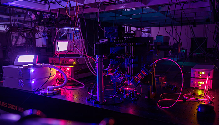 Illuminated equipment in a dark lab in the Photon Science Institute