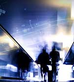 People walking towards a bright light and web of nodes illuminated in the background