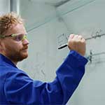 Student writing on a whiteboard