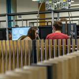 Male and female sat next to each other in lab
