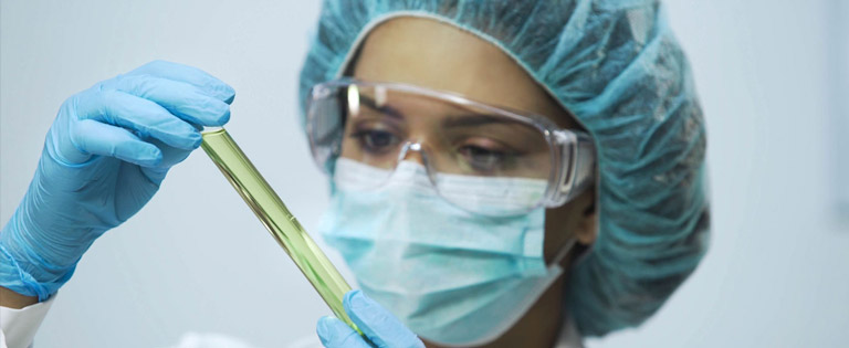 Lab assistant analysing biomaterial in tubes
