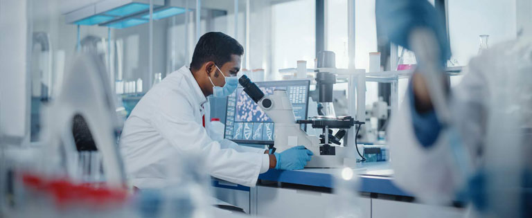 Scientist Looking into a microscope