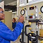 Female in a lab coat operating lab equipment