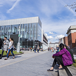Students outside a tall glass building